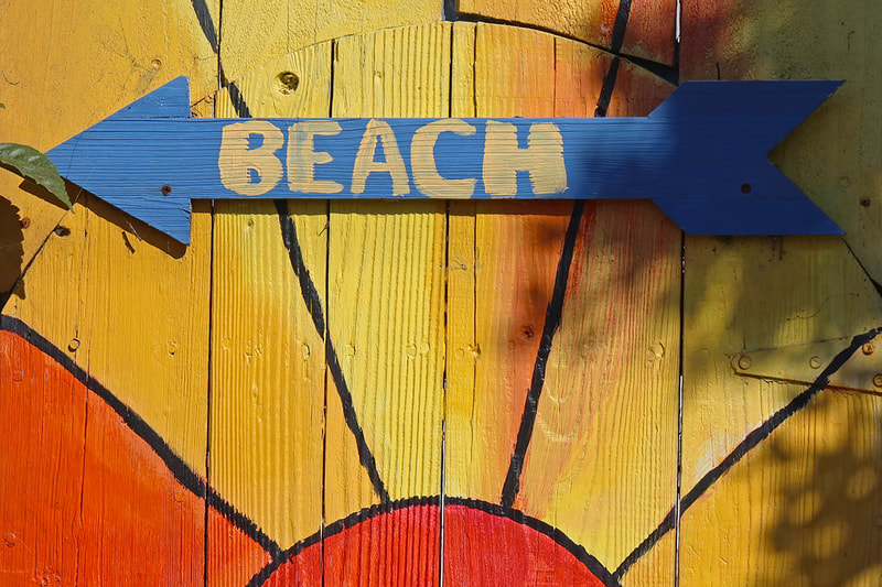 fence with beach arrow
