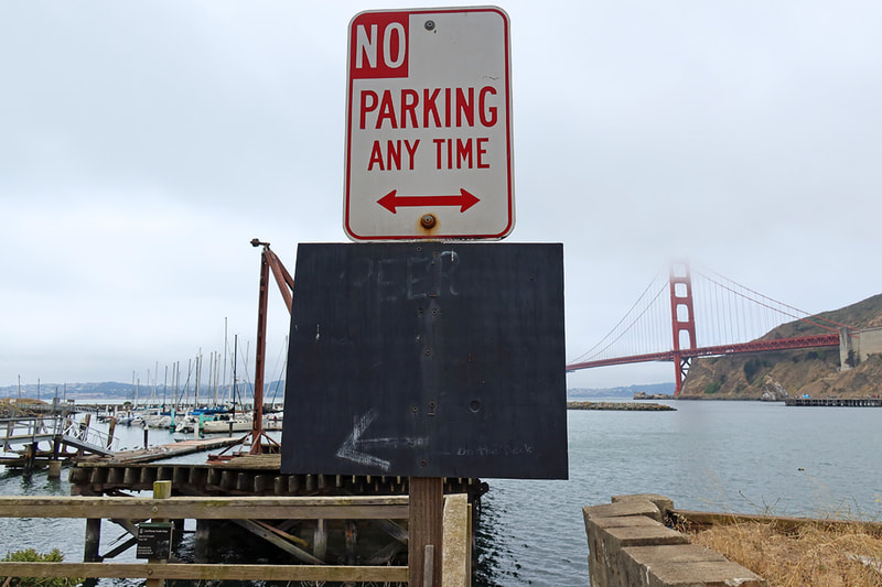 no parking and  faded beer sign