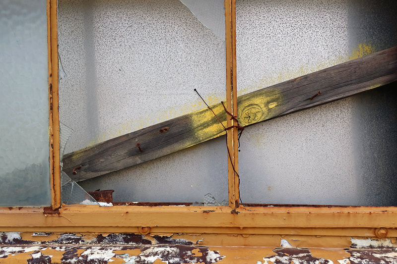 broken window with wood board