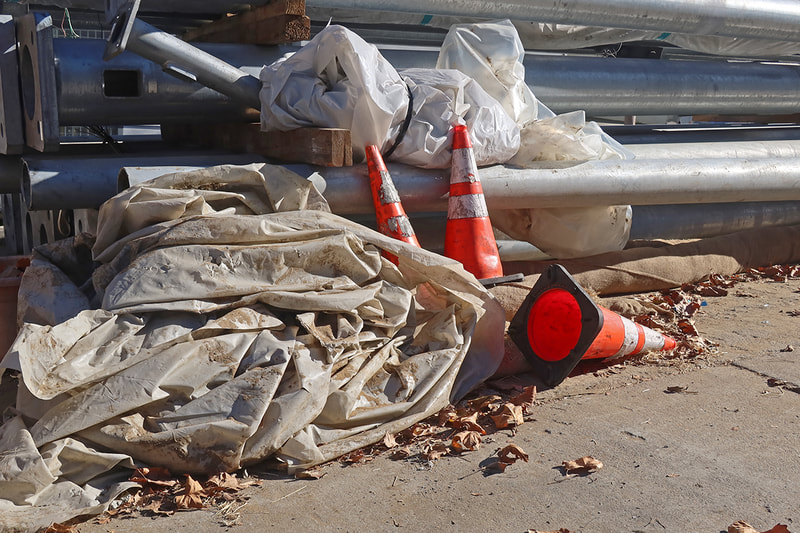 caution cones and plastic tarp