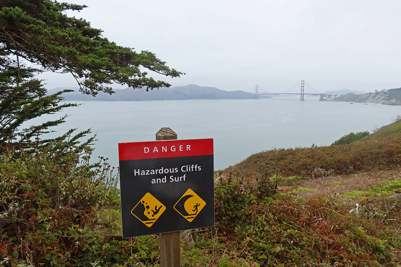 hazardous cliffs and surf sign