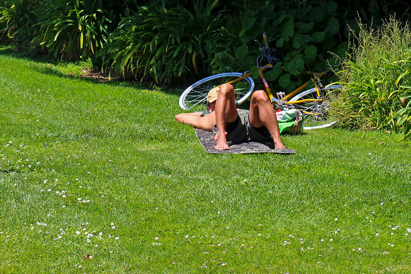 person resting with bike in the park
