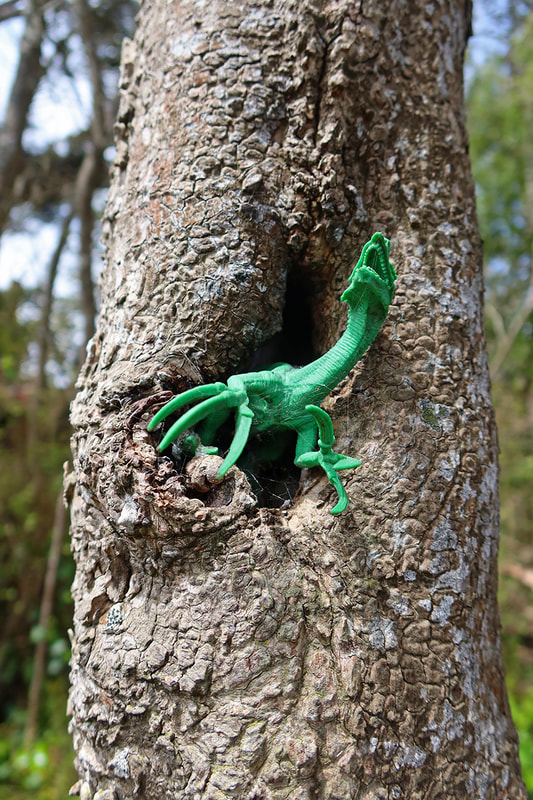 dinosaur toy in tree