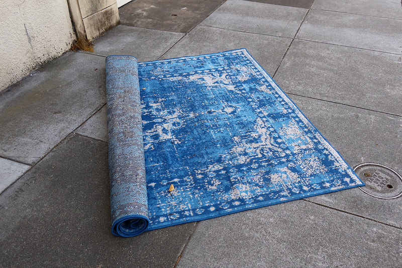 blue rug on sidewalk