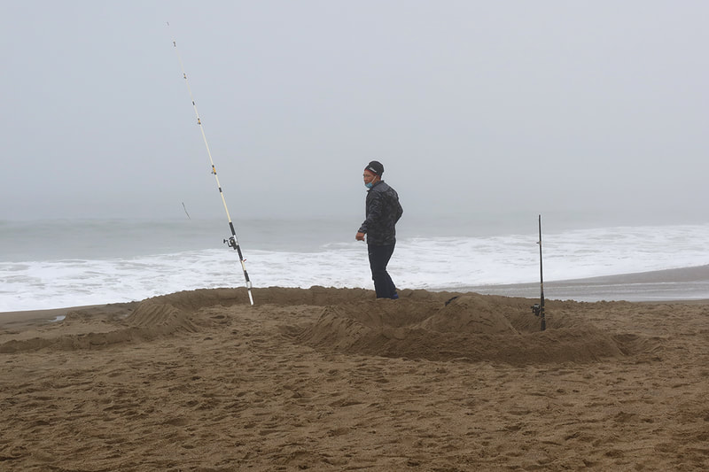 fisherman with sand barrier