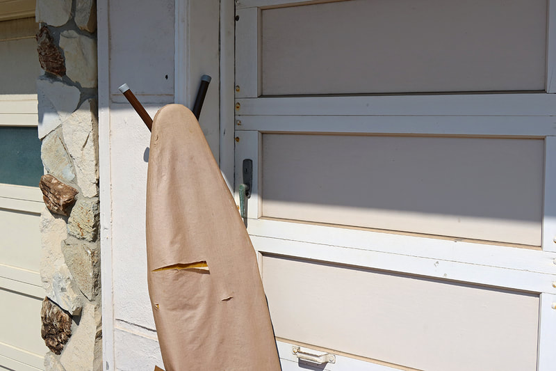 ironing board leaning on garage door