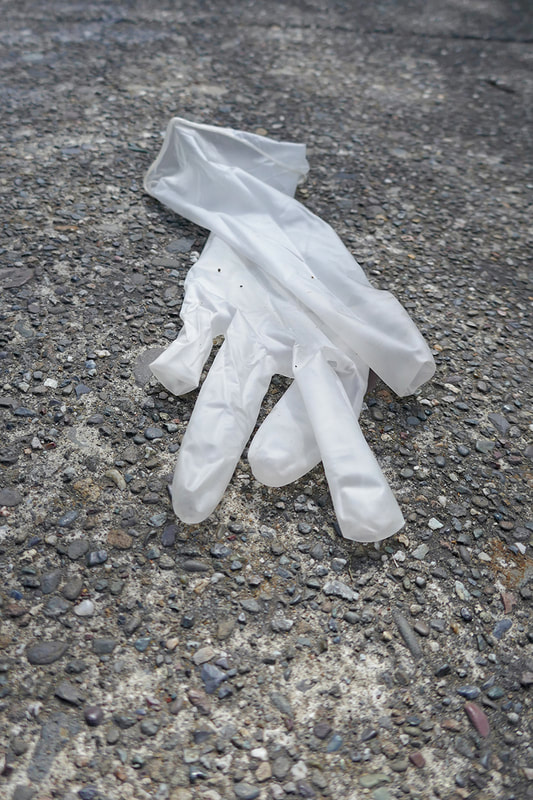 medical glove on pavement