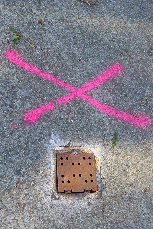 pink X and drain cover