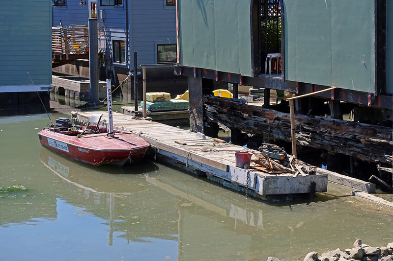 dock beside decaying houseboat