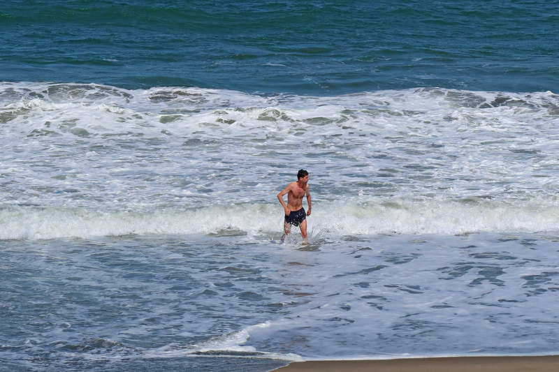 man walking out of ocean