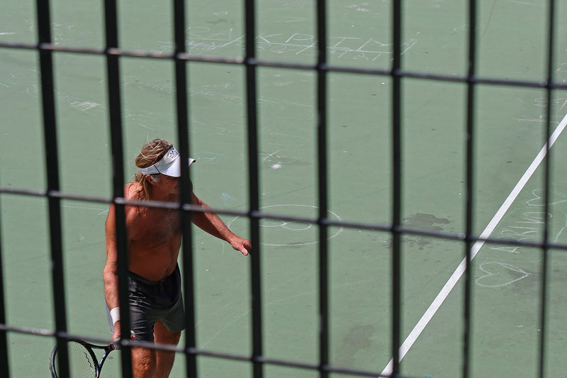 shirtless man with racket