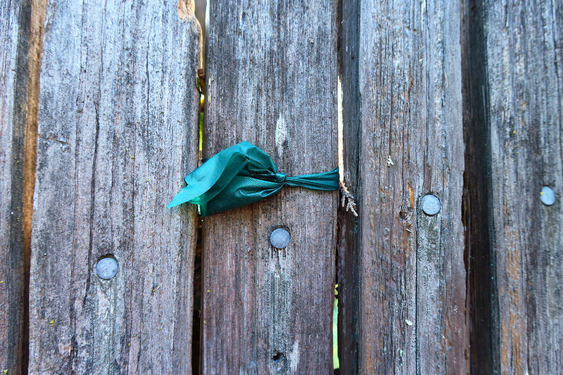 green ribbon on fence