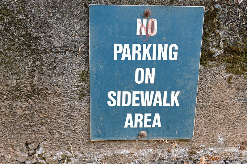 "No parking on sidewalk area" sign