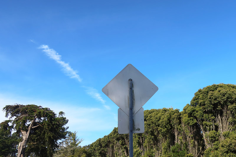 Back of road sign and blue sky
