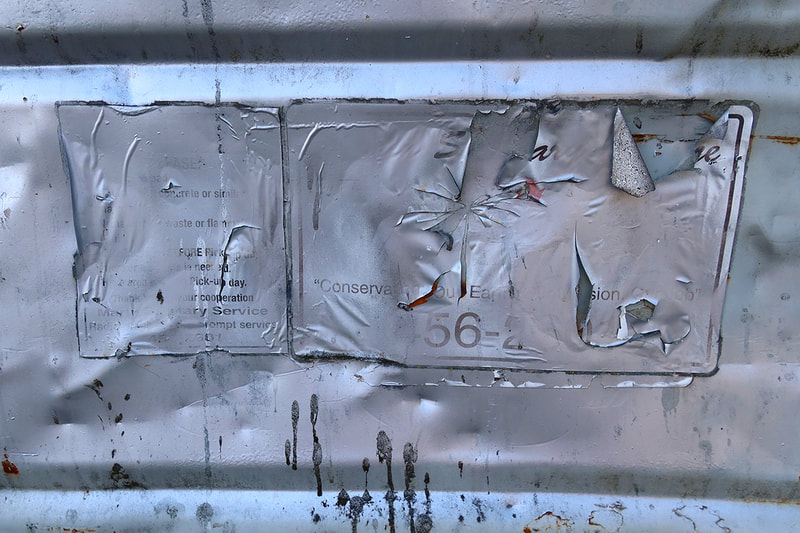 silver paint on dumpster