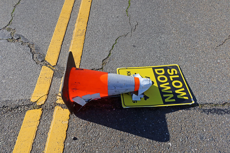 caution cone and slow down sign