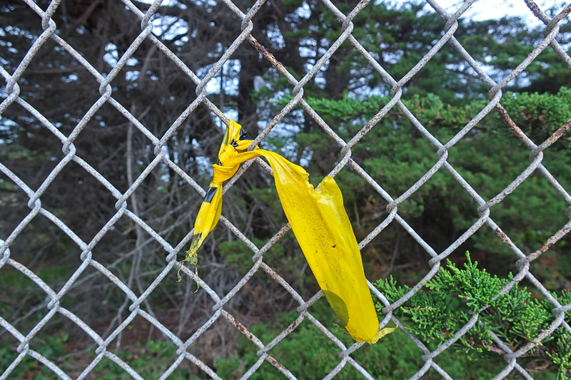 small piece of caution tape on fence