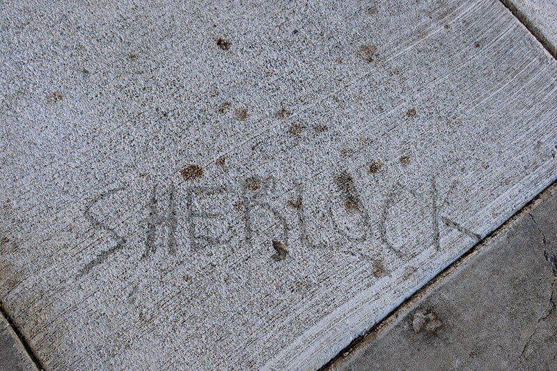 Sherlock written on sidewalk