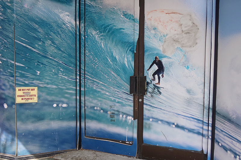 door with decal of man surfiing