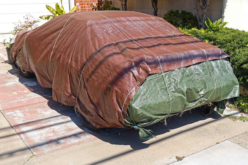 car covered with tarps