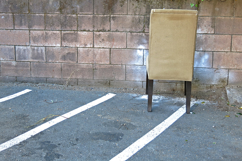yellow chair in parking lot