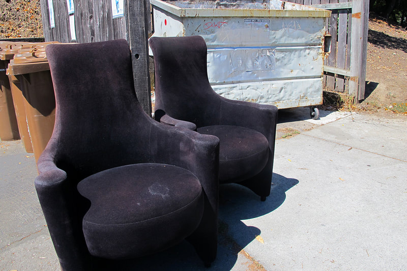black chairs near dumpster