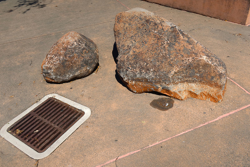 two large rocks and a drain