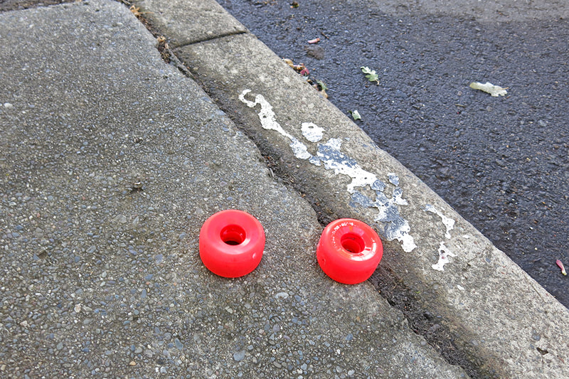 red skate wheels on sidewalk