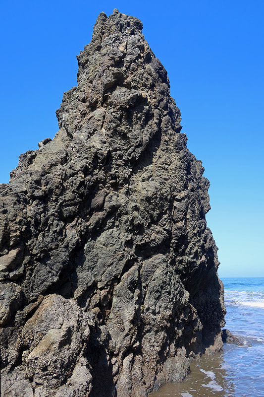 large rock formation on beach