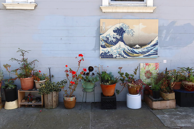 sidewalk garden with painting of wave