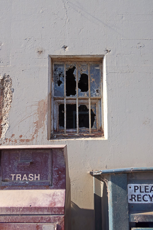 broken window and trash bins