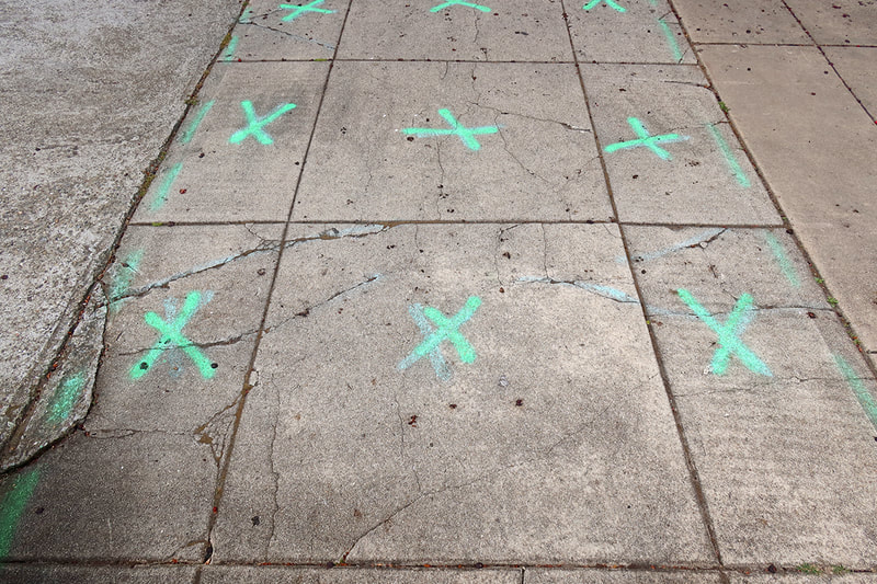 green x marks on street
